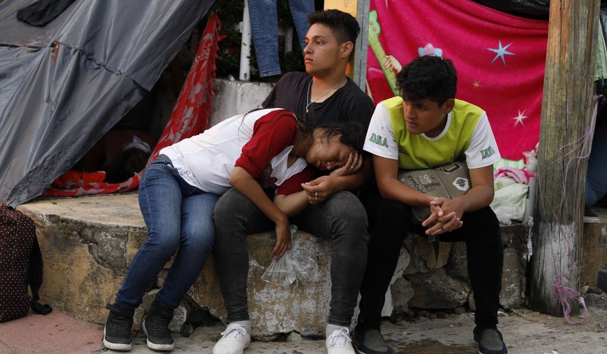 Central American migrants rest as a thousands-strong caravan slowly making its way toward the U.S. border stops for the night in Pijijiapan, Chiapas state, Mexico, Thursday, Oct. 25, 2018. Little by little, sickness, fear, and police harassment are whittling down the migrant caravan making its way to the U.S. border, with many of the 4,000 to 5,000 migrants camped overnight in the southern town of Mapastepec complaining of exhaustion.(AP Photo/Rebecca Blackwell)