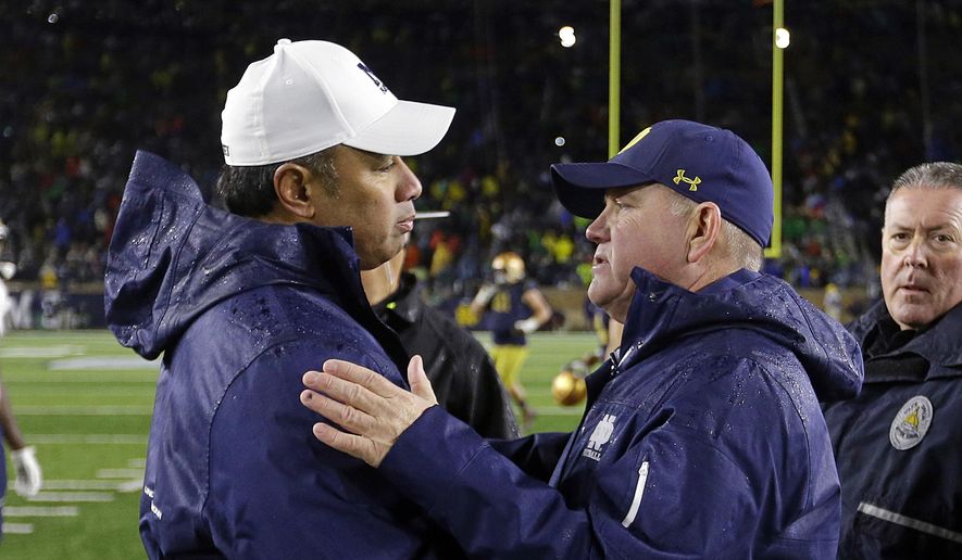 In this Nov. 18, 2017, file photo, Notre Dame head coach Brian Kelly, right, greets Navy head coach Ken Niumatalolo following an NCAA college football game in South Bend, Ind. No. 3 Notre Dame faces Navy on Saturday in San Diego.  (AP Photo/Michael Conroy, File) **FILE**