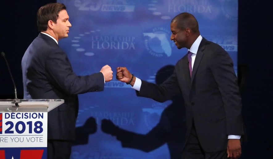 IN this Oct. 24, 2018, photo, Florida gubernatorial candidates, Republican Ron DeSantis, left, and Democrat Andrew Gillum fist bump after a debate at Broward College in Davie, Fla. The final stretch of the midterm campaign is increasingly dominated by debate over one of the most sensitive issues in American political culture: Race. In Florida, accusations of racism are playing a central role in the hotly-contested campaign for governor. DeSantis chafed at questions about his ties to supporters who have made inflammatory comments. (AP Photo/Wilfredo Lee, Pool)