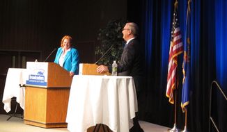 U.S. Senate candidates from North Dakota Heidi Heitkamp, left, and Kevin Cramer joke during one of the lighter moments in their debate in Fargo, N.D., on Friday, Oct. 26, 2018. Heitkamp, the Democratic senator, and Cramer, the Republican congressman, had lively discussions over health care, trade and social security in their second and last debate of the campaign.  (AP Photo/Dave Kolpack)