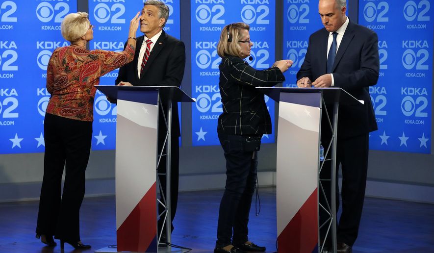 U.S. Sen.Bob Casey, D-PA, right, and Republican challenger U.S. Rep. Lou Barletta, second from left, prepare before their second debate, Friday Oct. 26, 2018, in the studio of KDKA-TV in Pittsburgh. Casey, 58, of Scranton, is seeking a third six-year term. Barletta, 62, of Hazleton, is in his fourth term in Congress. (AP Photo/Gene J. Puskar)