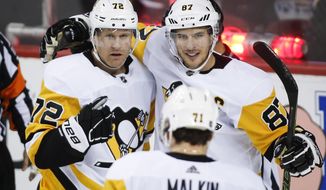 Pittsburgh Penguins&#x27; Sidney Crosby, right, celebrates his second goal with teammate Patric Hornqvist, of Sweden, during NHL hockey game action against the Calgary Flames in Calgary, Thursday, Oct. 25, 2018. (Jeff McIntosh/The Canadian Press via AP)
