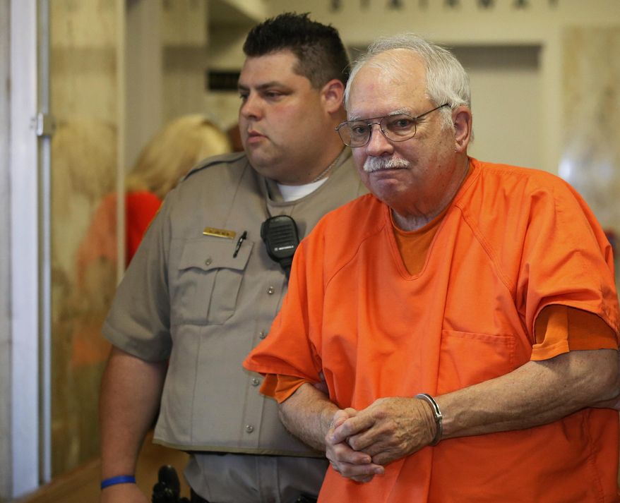 FILE - In this Tuesday, May 31, 2016 file photo, Robert Bates, a former Oklahoma volunteer sheriff's deputy who said he mistook his handgun for his stun gun when he fatally shot an unarmed suspect in 2015, is escorted from the courtroom following his sentencing at the courthouse in Tulsa, Okla. The former Oklahoma volunteer deputy has spoken publicly for the first time about his fatal shooting of an unarmed black man in Tulsa. Robert Bates told KTUL-TV in an interview aired Thursday, Oct. 25, 2018, that he feels "very bad" about the 2015 shooting that killed Eric Harris and said he's sorry for Harris' family, adding that it disrupted his life. (AP Photo/Sue Ogrocki, File)