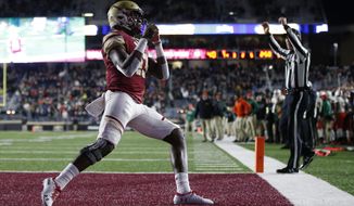 Boston College quarterback Anthony Brown celebrates his touchdown during the first half of an NCAA college football game against Miami in Boston, Friday, Oct. 26, 2018. (AP Photo/Michael Dwyer)