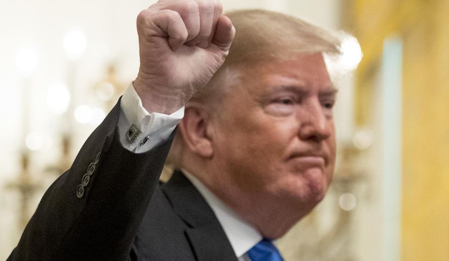 President Donald Trump holds up a fist after speaking at the 2018 Young Black Leadership Summit in the East Room of the White House, Friday, Oct. 26, 2018, in Washington. (AP Photo/Andrew Harnik)