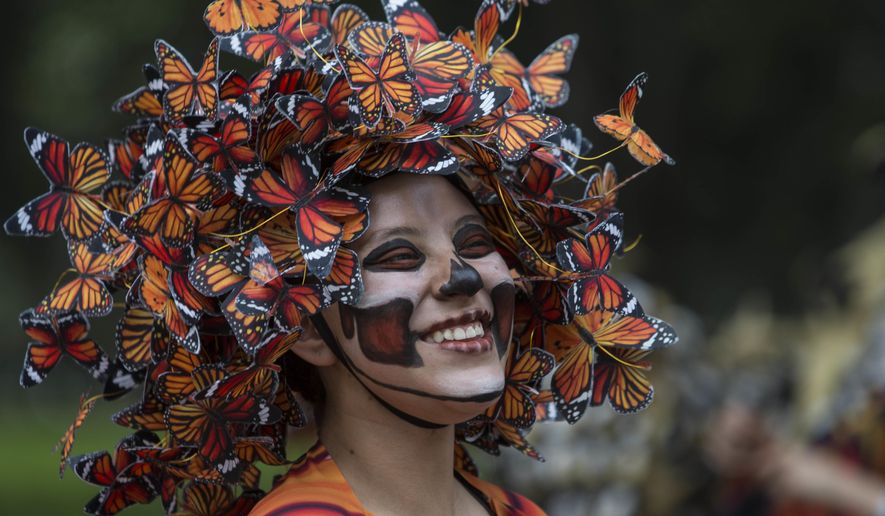 A performer participates in the Day of the Dead parade on Reforma avenue in Mexico City, Saturday Oct. 27, 2018. (AP Photo/Christian Palma)