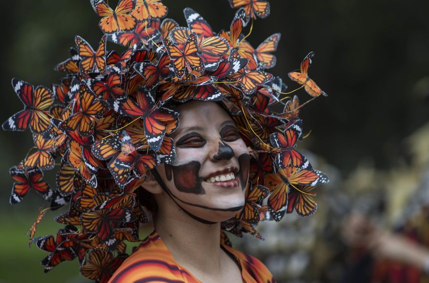 A performer participates in the Day of the Dead parade on Reforma avenue in Mexico City, Saturday Oct. 27, 2018. (AP Photo/Christian Palma)