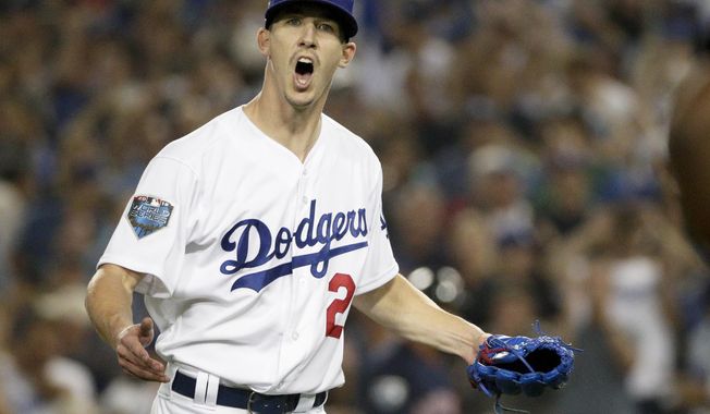 Los Angeles Dodgers starting pitcher Walker Buehler celebrates after the last out in the top of the seventh inning in Game 3 of the World Series baseball game against the Boston Red Sox on Friday, Oct. 26, 2018, in Los Angeles. (AP Photo/Jae C. Hong)