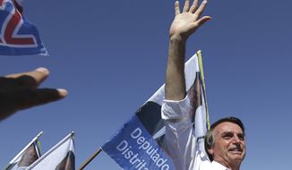 FILE - In this Sept. 5, 2018 file photo,  presidential candidate Jair Bolsonaro greets supporters during a campaign rally in Brasilia&#x27;s Ceilandia neighborhood, Brazil.  Few people in Brazil other than Bolsonaro’s most ardent supporters believed the far-right congressman had more than an outside shot of winning the Oct. 28, 2018 presidential race to lead Latin America&#x27;s largest nation. (AP Photo/Eraldo Peres, File)