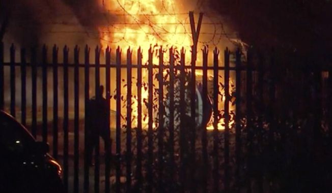 This image made from video shows a burning helicopter in a parking lot outside the King Power Stadium in Leicester, England shortly after a Premier League game on Saturday, Oct. 27, 2018. (Pool Photo via AP)