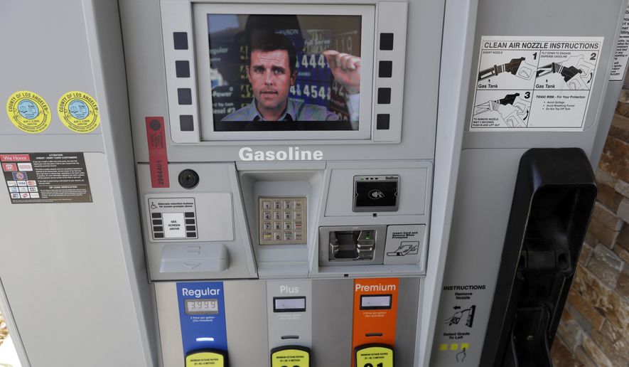 An ad supporting Proposition 6 plays on a screen on a pump at a gas station Wednesday, Oct. 24, 2018, in Santa Clarita, Calif. The ads are part of an advertising blitz by Proposition 6 supporters trying to drive home a message to voters to overcome what they see as a misleading title and summary on the ballot. The feud over messaging comes just weeks before an election where Californians will vote in a series of contentious races for Congress and state offices and ballot measures including the proposal to repeal an increase in gasolines taxes and vehicle fees slated to fund $5 billion in transportation projects a year. (AP Photo/Marcio Jose Sanchez)