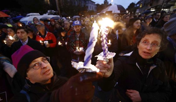 People light candles as they gather for a vigil in the aftermath of a deadly shooting at the Tree of Life Congregation, in the Squirrel Hill neighborhood of Pittsburgh, Saturday, Oct. 27, 2018. (AP Photo/Matt Rourke)