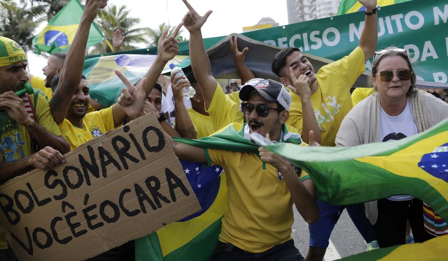 Supporters of Brazilian presidential candidate Jair Bolsonaro cheer as they gather outside his residence in Rio de Janeiro, Brazil, Sunday, Oct. 28, 2018, during the country&#x27;s  presidential runoff election. Brazilians on Sunday were weighing their hunger for radical change against fears that Bolsonaro, the  presidential front-runner, could threaten democracy as they cast ballots in the culmination of a bitter campaign that split many families and was frequently marred by violence. (AP Photo/Leo Correa)