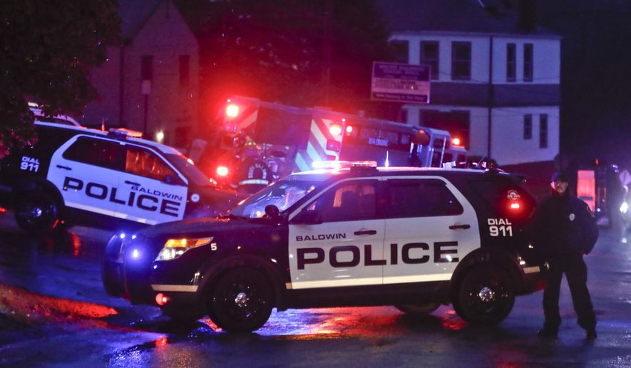 Emergency vehicles block off the area around the McAnulty Acres apartment complex as authorities continue their investigation of a shooting in a Pittsburgh synagogue where multiple people were killed on Saturday, Oct. 27, 2018 in Baldwin, Pa., a suburb south of Pittsburgh. (AP Photo/Keith Srakocic)