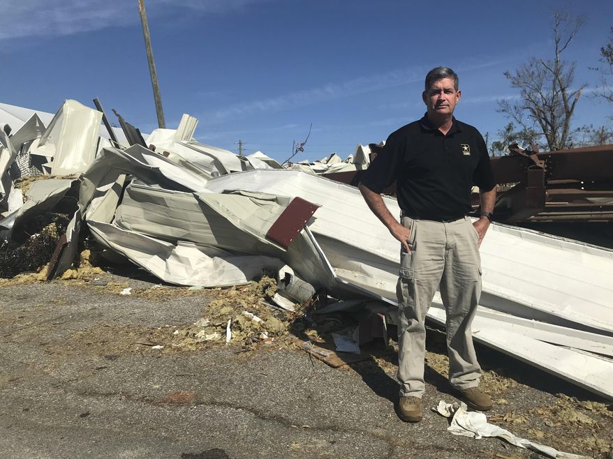 In this Oct. 24, 2018 photo, Panama City manager Mark McQueen poses for a photo near an area destroyed by Hurricane Michael in Panama City, Fla. The retired two- star general, started his new job two weeks before the storm. (AP Photo/Tamara Lush)