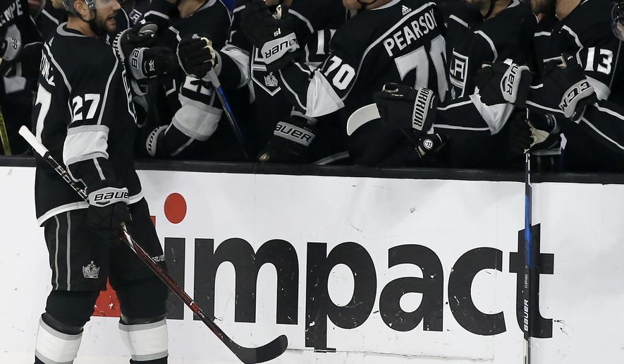 Los Angeles Kings defenseman Alec Martinez (27) celebrates scoring with teammates on the bench during last minute of the third period of an NHL hockey game against the New York Rangers in Los Angeles, Sunday, Oct. 28, 2018. The Kings won 4-3. (AP Photo/Alex Gallardo)