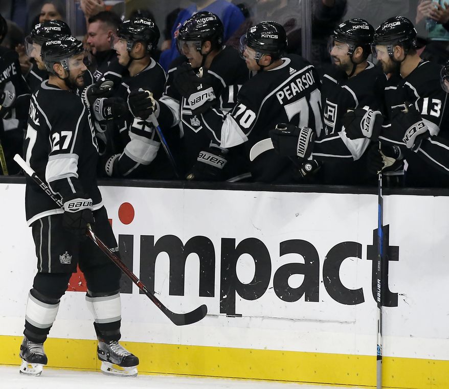 Los Angeles Kings defenseman Alec Martinez (27) celebrates scoring with teammates on the bench during last minute of the third period of an NHL hockey game against the New York Rangers in Los Angeles, Sunday, Oct. 28, 2018. The Kings won 4-3. (AP Photo/Alex Gallardo)