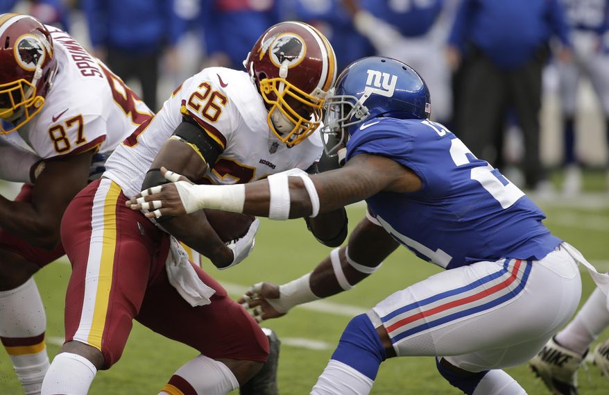 Washington Redskins running back Adrian Peterson (26) is hit by New York Giants strong safety Landon Collins (21) during the first quarter of an NFL football game, Sunday, Oct. 28, 2018, in East Rutherford, N.J. (AP Photo/Seth Wenig)