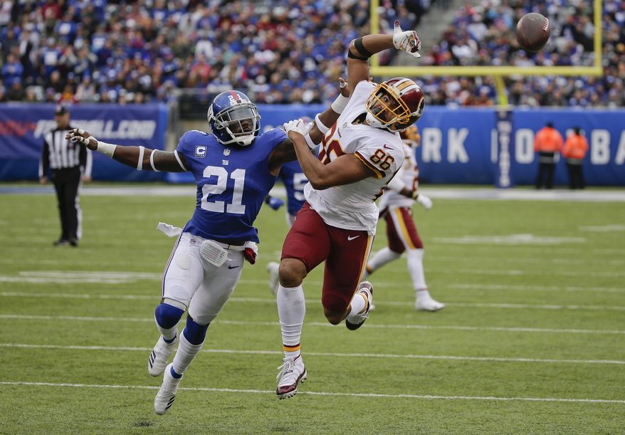 New York Giants strong safety Landon Collins (21) breaks up a pass intended for Washington Redskins tight end Jordan Reed (86) during the third quarter of an NFL football game, Sunday, Oct. 28, 2018, in East Rutherford, N.J. (AP Photo/Seth Wenig)