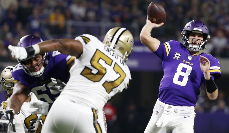 Minnesota Vikings quarterback Kirk Cousins (8) throws a pass over New Orleans Saints defensive end Alex Okafor (57) during the first half of an NFL football game, Sunday, Oct. 28, 2018, in Minneapolis. (AP Photo/Bruce Kluckhohn)