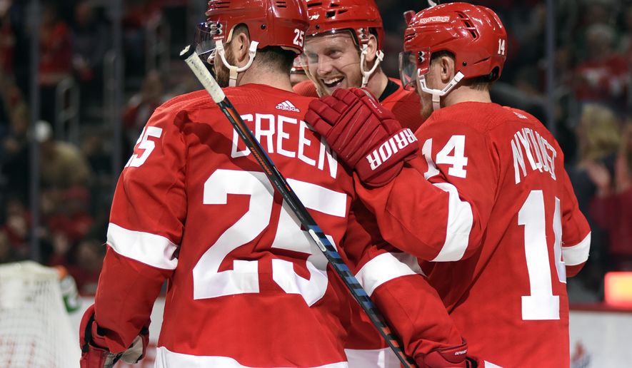 Detroit Red Wings right wing Anthony Mantha, center, is congratulated by defenseman Mike Green (25) and right wing Gustav Nyquist (14), of Sweden, after scoring a goal against the Dallas Stars in the second period of an NHL hockey game in Detroit, Sunday, Oct. 28, 2018. (AP Photo/Jose Juarez)