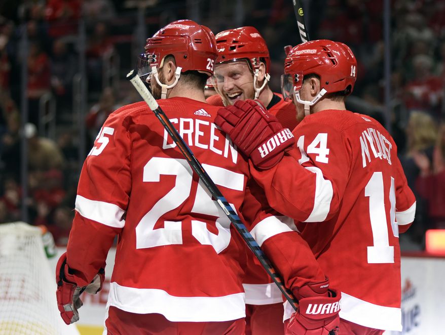 Detroit Red Wings right wing Anthony Mantha, center, is congratulated by defenseman Mike Green (25) and right wing Gustav Nyquist (14), of Sweden, after scoring a goal against the Dallas Stars in the second period of an NHL hockey game in Detroit, Sunday, Oct. 28, 2018. (AP Photo/Jose Juarez)