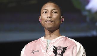 In this April 22, 2017, file photo, Pharrell Williams performs at To the Rescue! Los Angeles Human Society Benefit in Los Angeles. Williams is using music to sound the warning about climate change. The Grammy-winning musician appeared in Shanghai to debut a song titled 100 Years.&quot; (Photo by Richard Shotwell/Invision/AP)