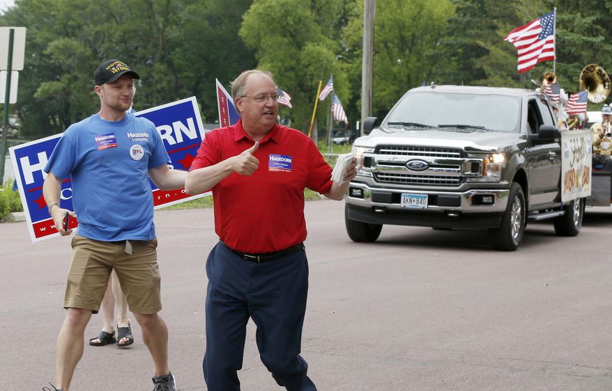 In this June 10, 2018, file photo, Minnesota 1st District Congressional candidate Jim Hagedorn gives a thumbs up as he works a parade in Waterville, Minn. (AP Photo/Jim Mone, File)