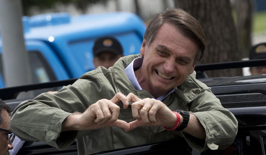 Jair Bolsonaro, presidential candidate with the Social Liberal Party, gestures after voting in the presidential runoff election in Rio de Janeiro, Brazil, Sunday, Oct. 28, 2018. Bolsonaro is running against leftist candidate Fernando Haddad of the Workers’ Party.  (AP Photo/Silvia izquierdo)