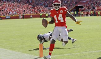 Kansas City Chiefs wide receiver Sammy Watkins (14) scores a touchdown in front of Denver Broncos safety Will Parks (34) during the second half of an NFL football game in Kansas City, Mo., Sunday, Oct. 28, 2018. (AP Photo/Orlin Wagner)