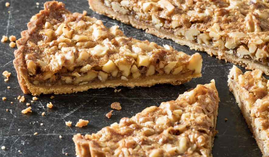This undated photo provided by America's Test Kitchen in October 2018 shows a rustic walnut tart in Brookline, Mass. This recipe appears in “The Complete Make-Ahead Cookbook.” (Daniel J. van Ackere/America's Test Kitchen via AP)