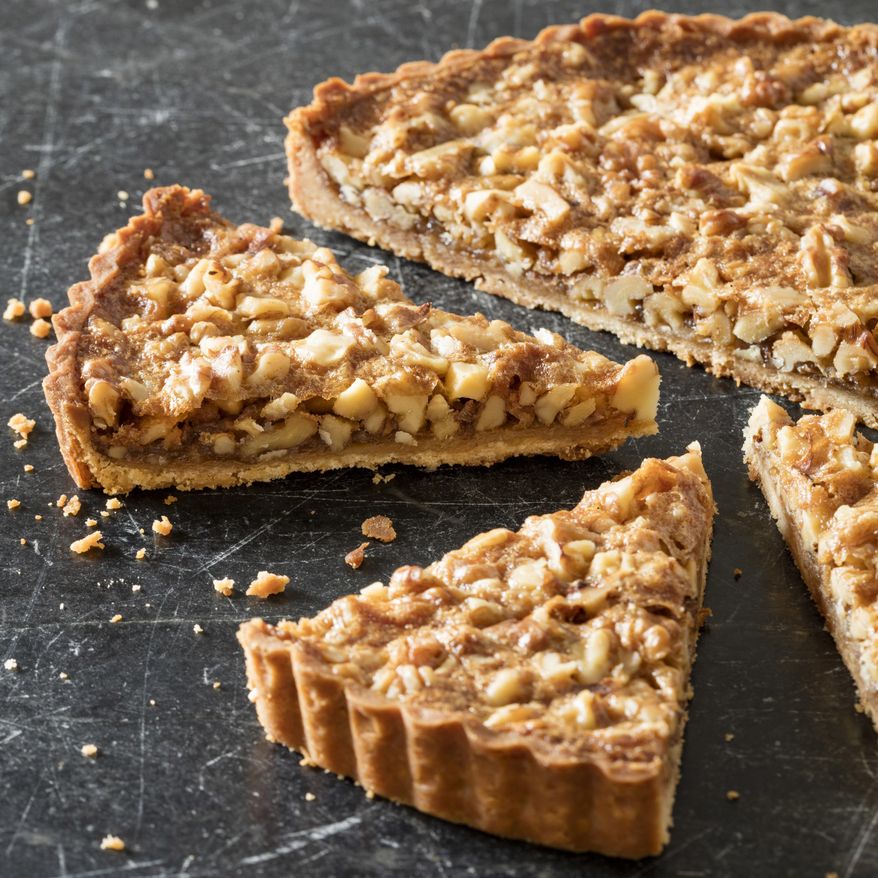 This undated photo provided by America's Test Kitchen in October 2018 shows a rustic walnut tart in Brookline, Mass. This recipe appears in “The Complete Make-Ahead Cookbook.” (Daniel J. van Ackere/America's Test Kitchen via AP)