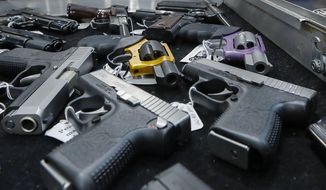 In this Jan. 26, 2013, photo, handguns are displayed on a vendor&#x27;s table at an annual gun show in Albany, N.Y. In a study looking at data from 2006-14, serious gun injuries including many from assaults sent 75,000 U.S. children and teens to emergency rooms over the nine years. Results were released on Monday, Oct. 29, 2018. (AP Photo/Philip Kamrass) **FILE**
