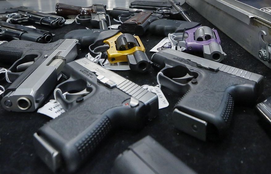 In this Jan. 26, 2013, photo, handguns are displayed on a vendor's table at an annual gun show in Albany, N.Y. In a study looking at data from 2006-14, serious gun injuries including many from assaults sent 75,000 U.S. children and teens to emergency rooms over the nine years. Results were released on Monday, Oct. 29, 2018. (AP Photo/Philip Kamrass) **FILE**
