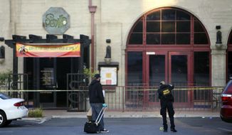 Members of the Riverside Police Department investigate the scene of a shooting at Sevilla Nightclub in Riverside, Calif., on Monday, Oct. 29, 2018. Several people were shot and wounded during a Halloween party at the nightclub, police said. (Stan Lim/The Orange County Register via AP)