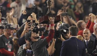 Boston Red Sox&#39;s Steve Pearce holds the MVP trophy after Game 5 of baseball&#39;s World Series against the Los Angeles Dodgers on Sunday, Oct. 28, 2018, in Los Angeles. The Red Sox won 5-1 to win the series 4 game to 1. (AP Photo/Mark J. Terrill)