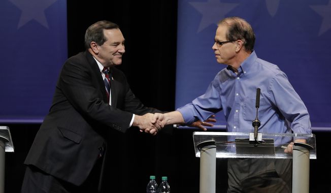 Democratic Sen. Joe Donnelly, left, shakes hands with Republican former state Rep. Mike Braun following a U.S. Senate Debate, Tuesday, Oct. 30, 2018, in Indianapolis. (AP Photo/Darron Cummings, Pool)