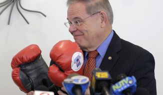 Democratic Sen. Bob Menendez receives a gift of boxing gloves before speaking to a group of mostly seniors in Bloomfield, N.J., Tuesday, Oct. 30, 2018. Menendez has cast Republican rival Bob Hugin as President Donald Trump&#39;s closest Senate ally-in the-making, but the former drug company executive said he&#39;s &quot;no Trump Republican&quot; and bashed him over tossed-out corruption charges in the closely watched contest. (AP Photo/Seth Wenig)
