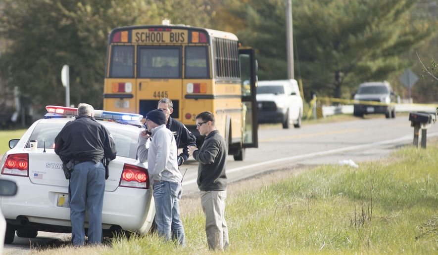 Emergency personnel responded to a scene of a collision that killed three children crossing SR 25 as they were boarding their school bus north of Rochester, Indiana on Tuesday, Oct. 30, 2018,. (Santiago Flores/South Bend Tribune via AP)
