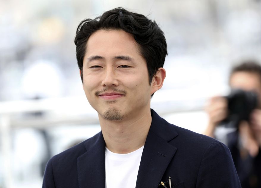 FILE - In this May 17, 2018 file photo, actor Steven Yeun appears during a photo call for his film "Burning" at the 71st international film festival, Cannes, southern France. Yeun is best known for his role as Glenn on “The Walking Dead,” but audiences are going to get to see another side of him in the acclaimed Korean film “Burning.” Now playing in limited release, the film is based on a short story by Haruki Murakami. (Photo by Vianney Le Caer/Invision/AP, File)