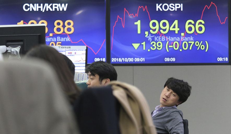 A currency trader works at the foreign exchange dealing room of the KEB Hana Bank headquarters in Seoul, South Korea, Tuesday, Oct. 30, 2018. Asian shares were mostly higher on Tuesday as traders took the weaker yuan as a sign that Chinese exports can remain competitive even if a trade dispute with Washington heats up. (AP Photo/Ahn Young-joon)