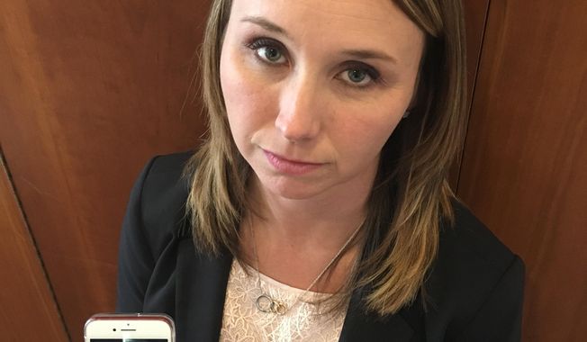 In this Sept. 27, 2018, photo Mary Laile holds a cellphone photo of her late cousin, Donna Castleberry in Columbus, Ohio. Laile and Castleberry's parents want more information about her shooting death at the hands of an undercover Columbus police officer in an unmarked car in August. The FBI is investigating the agency's vice squad after that incident and the July arrest of porn actress Stormy Daniels. (AP Photo/Andrew Welsh-Huggins)