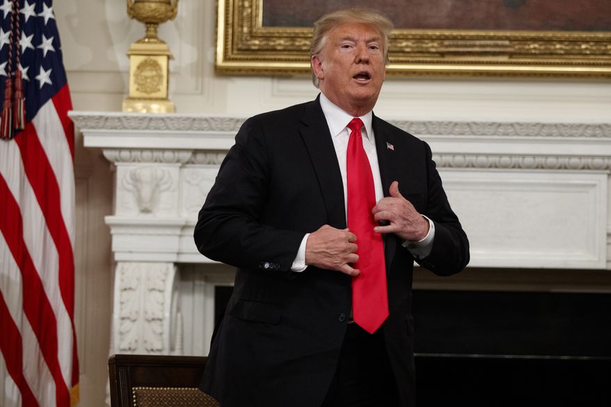 President Donald Trump stands up to leave the "Our Pledge to America's Workers" event in the State Dining Room of the White House, Wednesday, Oct. 31, 2018, in Washington. (AP Photo/Evan Vucci)