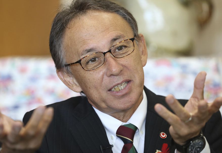 Governor of Okinawa, Denny Tamaki, speaks during a interview with The Associated Press in Tokyo, Wednesday, Oct. 31, 2018. Tamaki, the newly elected governor of the southern Japanese island of Okinawa, is headed to the U.S. with a message to the American people: Stop building the military base and build peace instead. (AP Photo/Koji Sasahara)