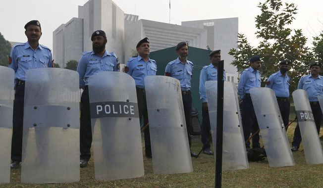 Pakistani police officers stand guard outside the supreme court in Islamabad, Pakistan, Wednesday, Oct. 31, 2018. Pakistan&#x27;s top court acquitted a Christian woman who has been on death row since 2010 for insulting Islam&#x27;s Prophet Muhammad. In Wednesday&#x27;s verdict, the court ordered authorities to free Asia Bibi. (AP Photo/Anjum Naveed)