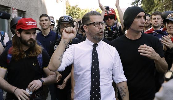 Gavin McInnes, center, founder of the far-right group Proud Boys, is surrounded by supporters after speaking at a rally in Berkeley, California, in this April 27, 2017, file photo. (AP Photo/Marcio Jose Sanchez)