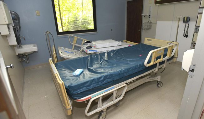 This Aug. 25, 2018, photo shows beds and other equipment being assembled in an ICU room in the Lee County Medical Center in Pennington Gap, Va. Virginia&#x27;s westernmost county had appeared to be on track to reopen its only hospital, a rare accomplishment a rural community anywhere in the country. But questions involving the company expected to run the Lee County facility have thrown the plan into question at the last minute. (AP Photo/Earl Neikirk)