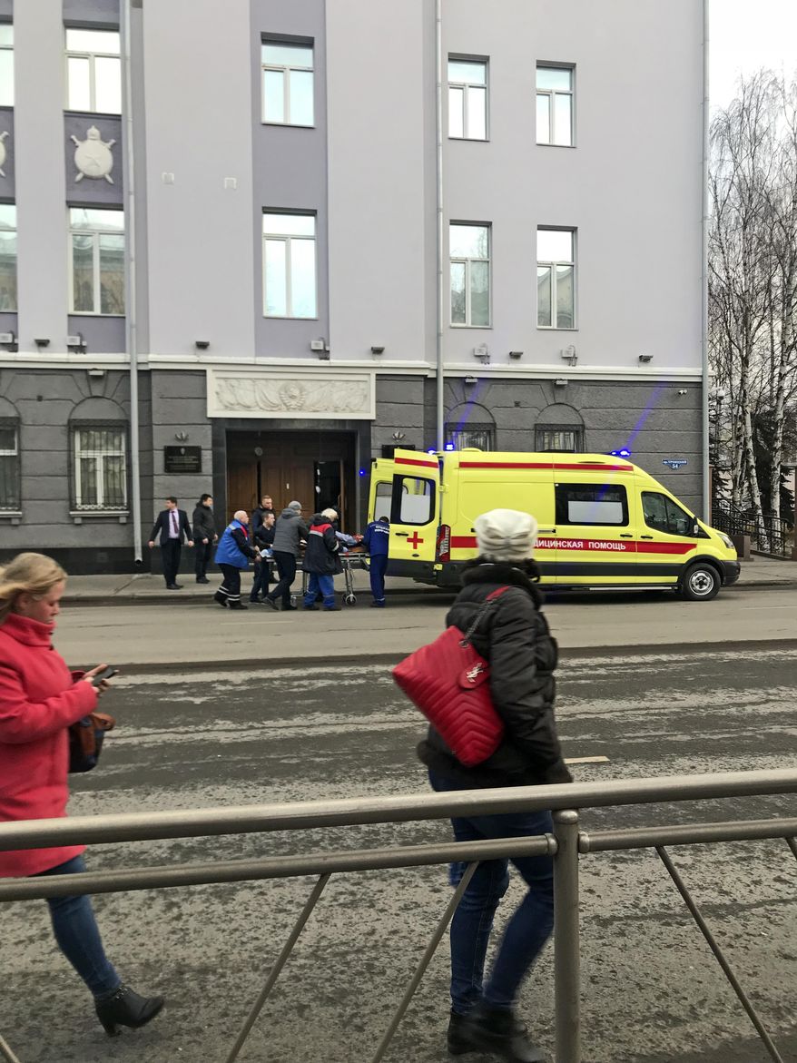 An ambulance carries a casualty after an explosion at the entrance of an FSB office in the city of Akhangelsk, in northern Russia, Wednesday, Oct. 31, 2018. The local governor says one person has been killed and three injured after a bomb went off at the entrance of the local branch of Russia's main intelligence agency. (AP Photo/Maria Vavilina)
