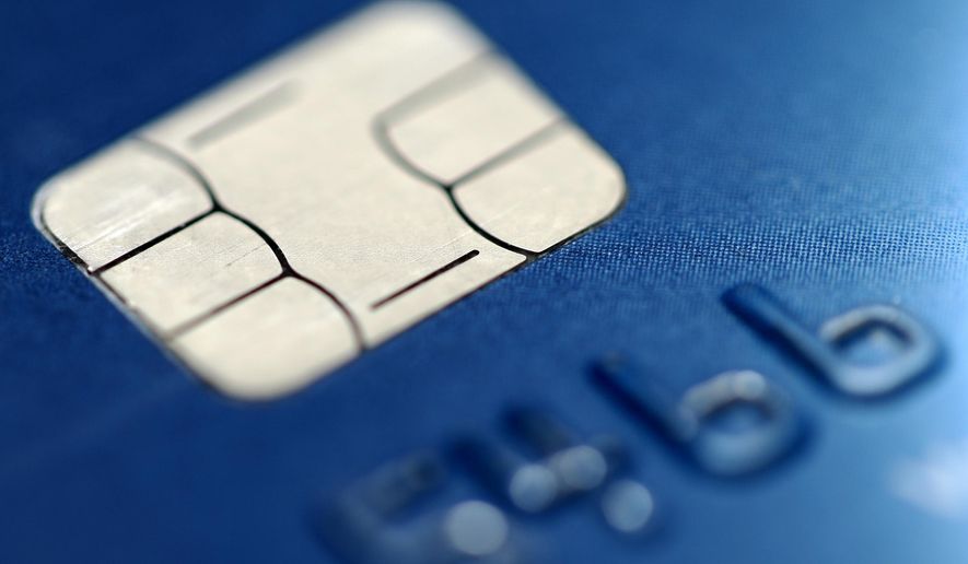 FILE- This June 10, 2015, file photo shows a chip credit card in Philadelphia. Banks, particularly online institutions, have been getting more competitive with the rates they are offering on savings, CDs and even checking accounts to draw more customers. That means a savvy consumer may be able to earn far beyond the norm if they are willing to shop around. (AP Photo/Matt Rourke, File)
