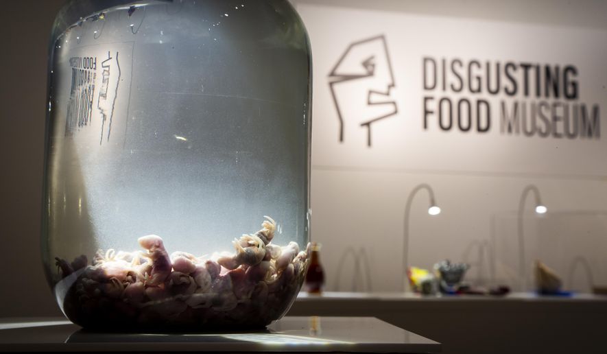 In this photo taken on Sept. 22, 2018 a container of Mice wine on display at the Disgusting Food Museum, in Malmo, Sweden. Baby mice are drowned and brewed in rice wine and the brew is matured for up to a year before drinking. Dozen of foods likely to provoke extreme disgust in many people _ but considered palatable, even precious delicacies, in their home cultures _ go on display Wednesday, Oct. 31, 2018 as the Disgusting Food Museum makes its world premiere in Malmo, Sweden. (Anja Barte Telin via AP)